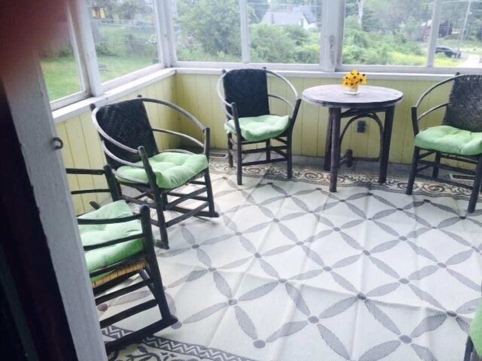 Screened porch, like the dining room the porch faces west, to the water.