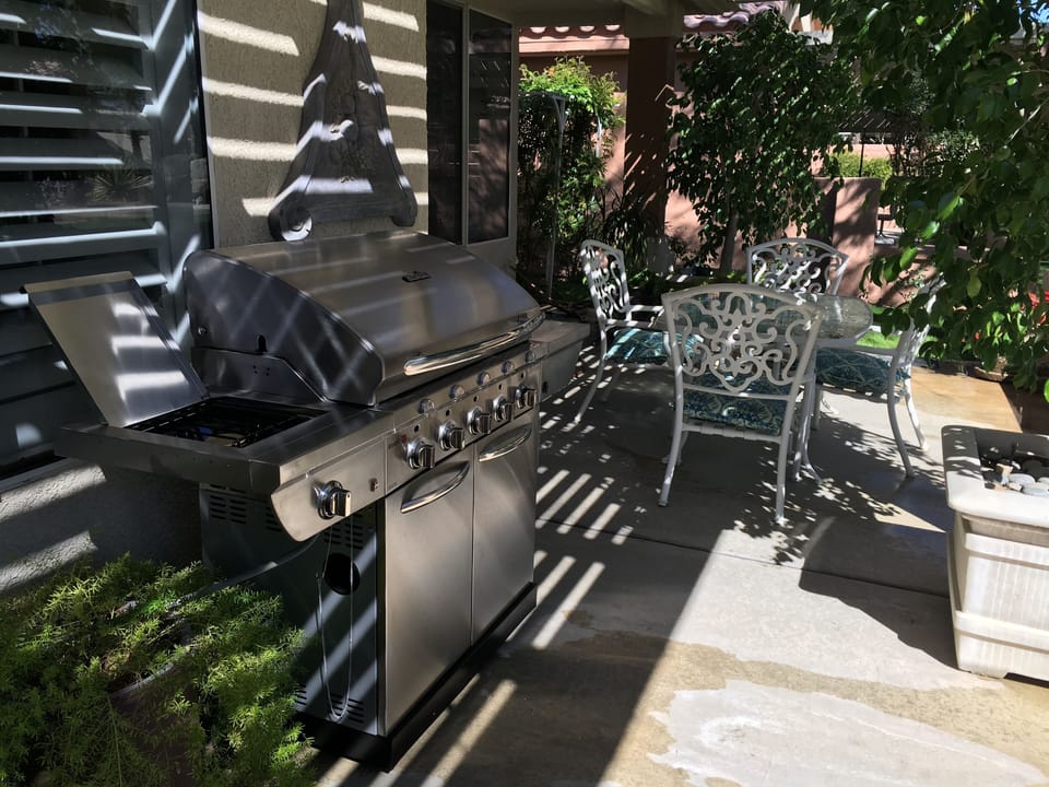 Back patio dining area including 5 burner grill plus side burner