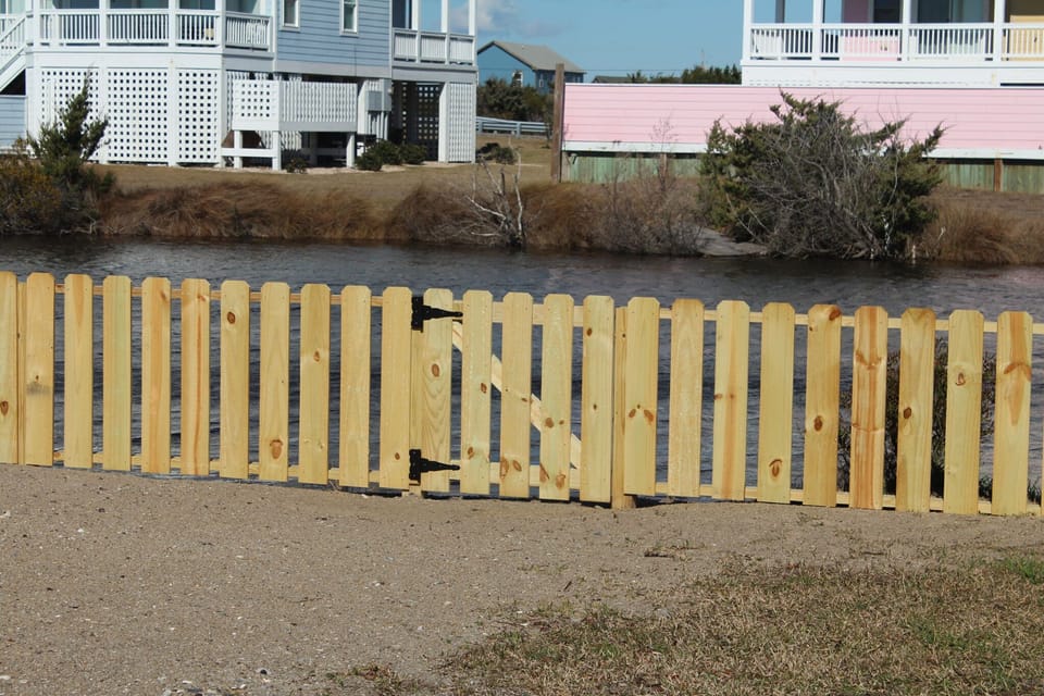 Fenced yard leading to the pond
