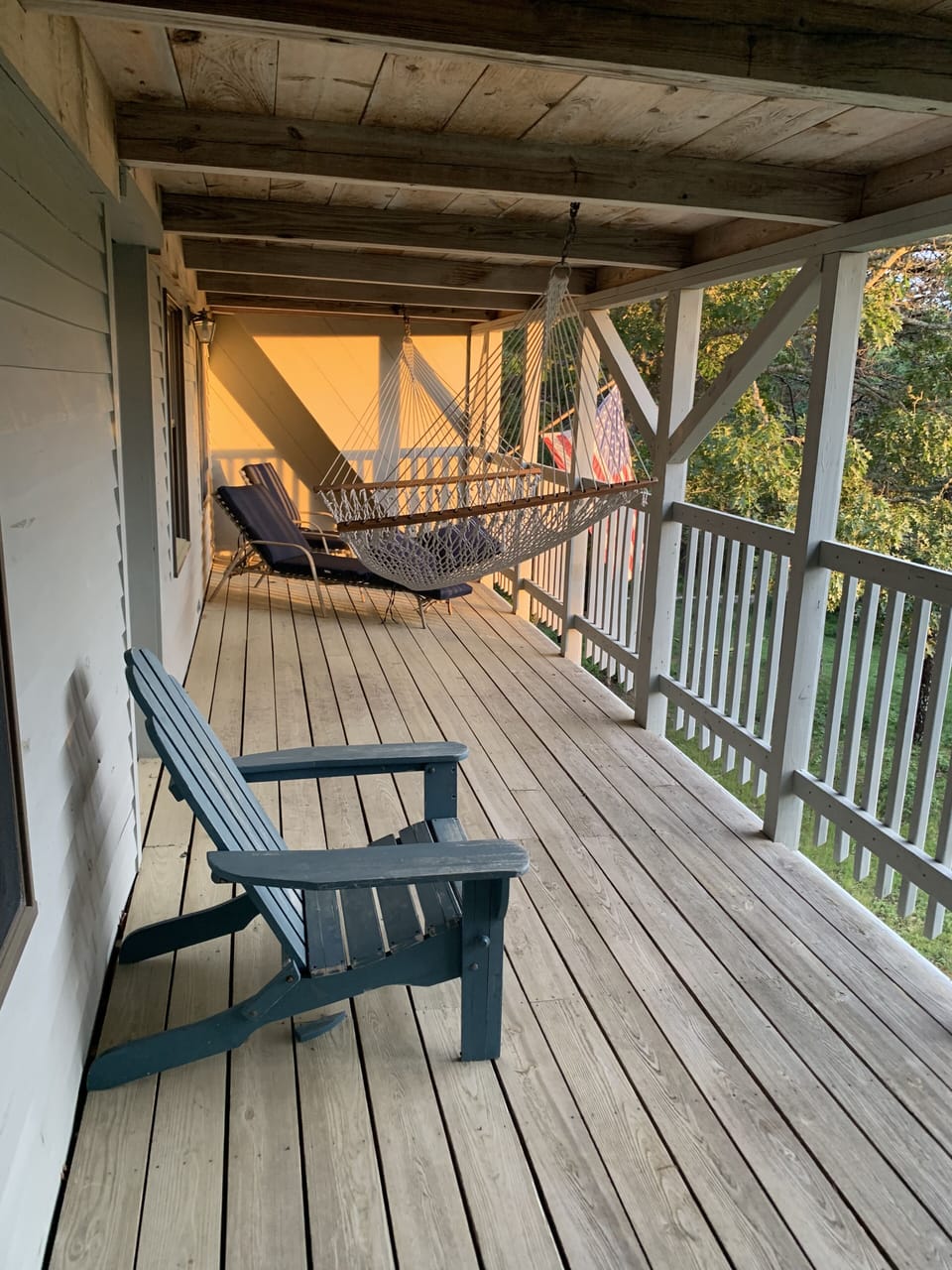 Second floor deck with hammock and lounge chairs accessed off secondary bedroom