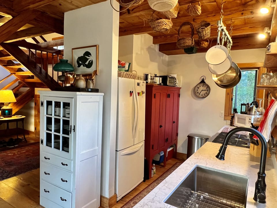 Chef's galley kitchen with deep, stainless steel sink and antique pantry