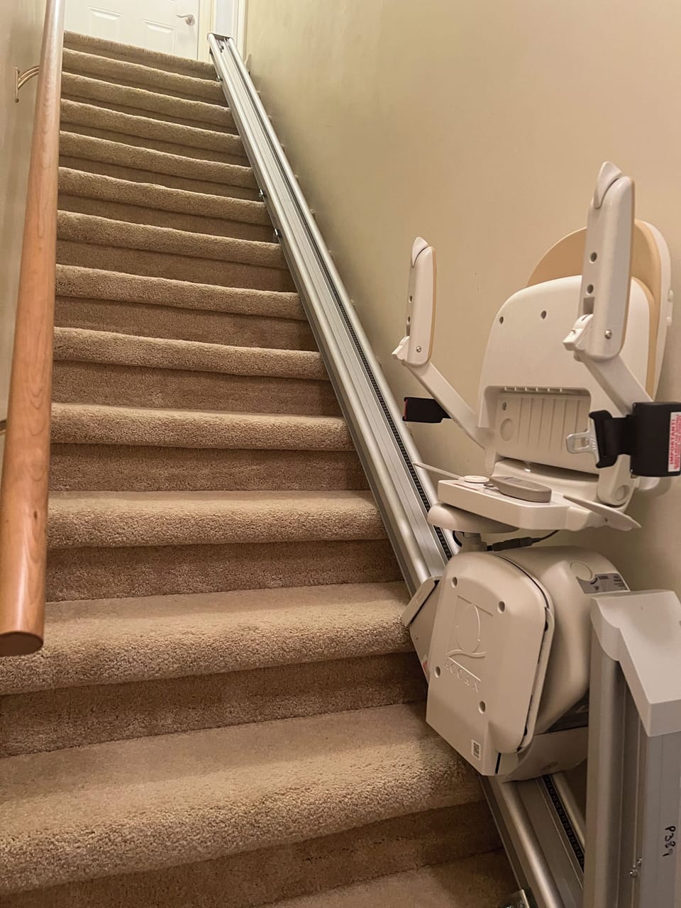 Stairlift from garage entrance to main floor for elderly & disabled guests.