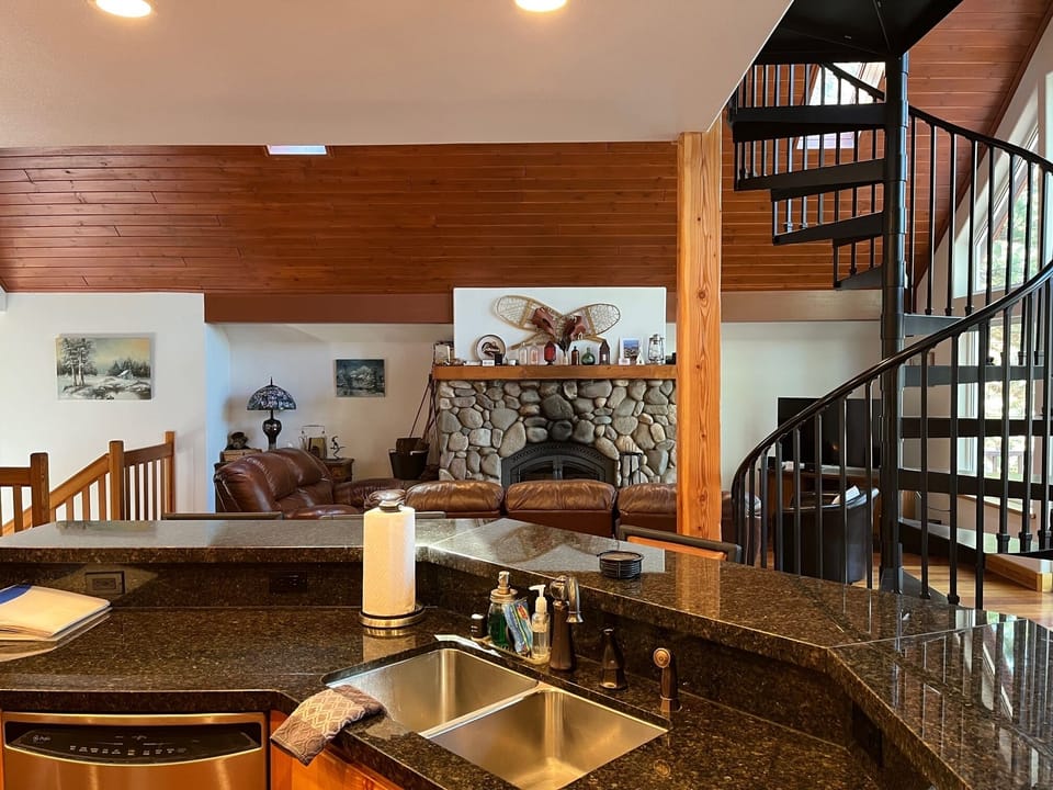 kitchen view into the living room and spiral staircase up to the loft