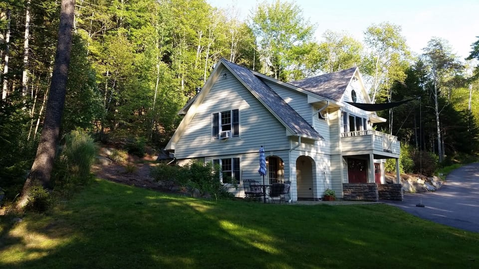 Later afternoon sun shades the house and lawn.
