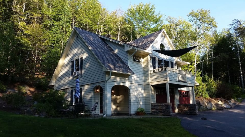 Dappled sunlight shows off the house's architectural features.