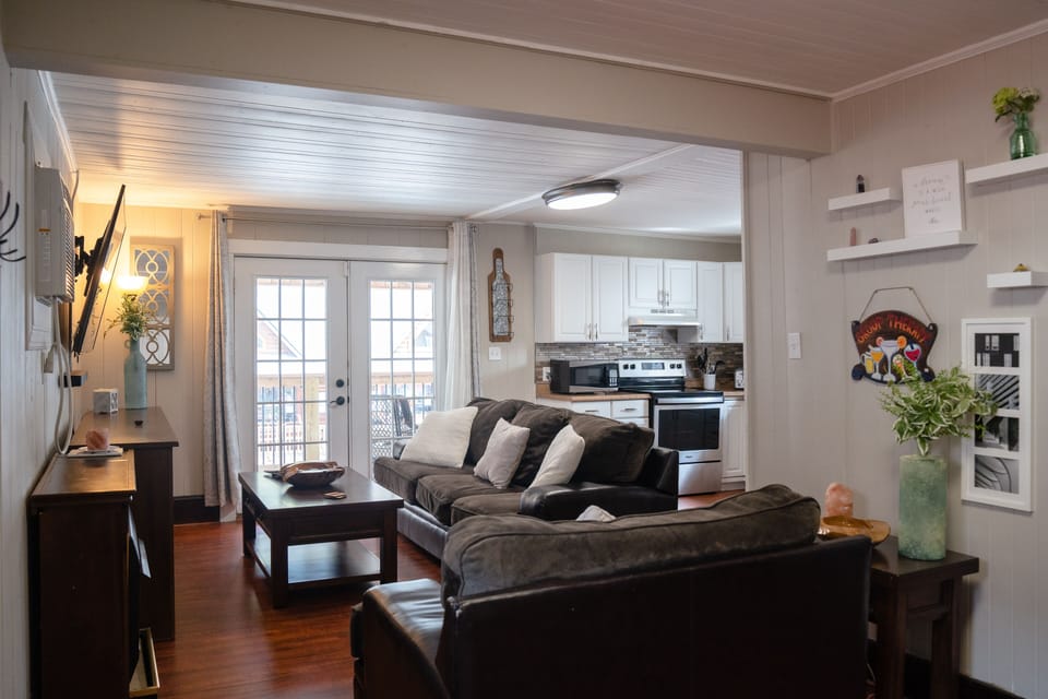 Living room featuring two couches, coffee table, and brand new 65-inch smart TV