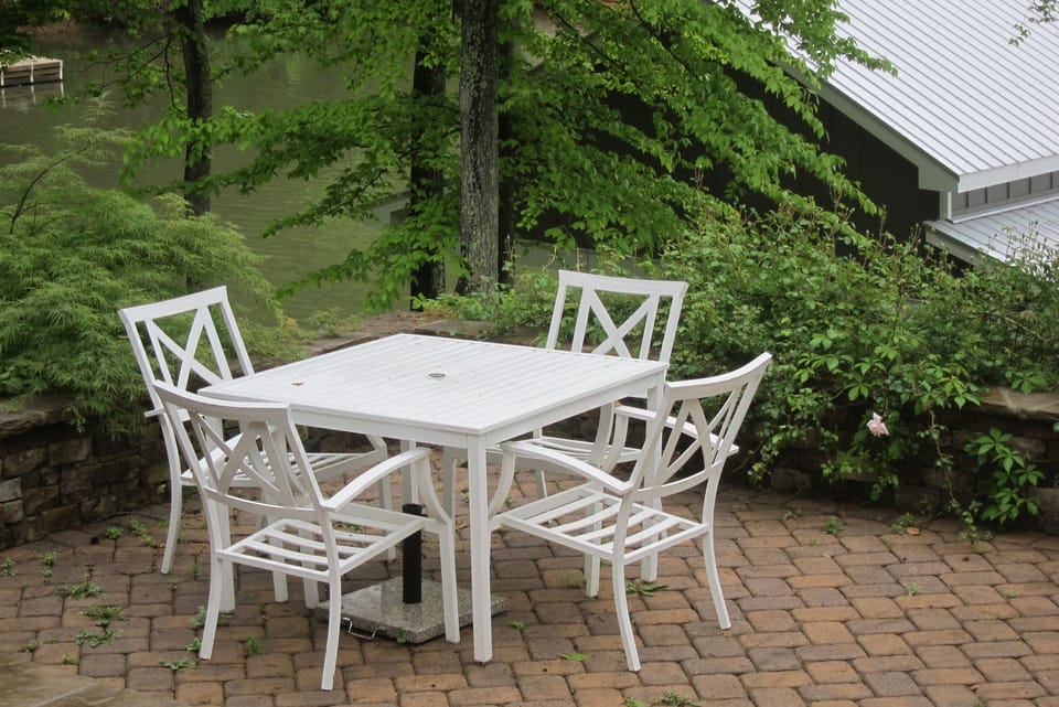 outdoor dining overlooking the garden and the waterfront view