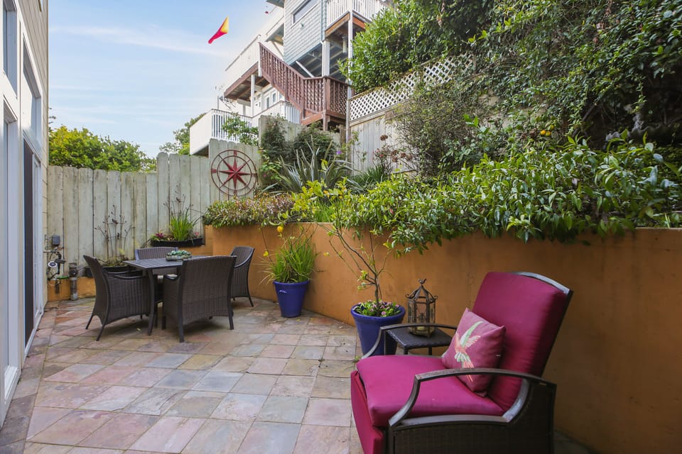 Spacious patio with outdoor seating and grill.