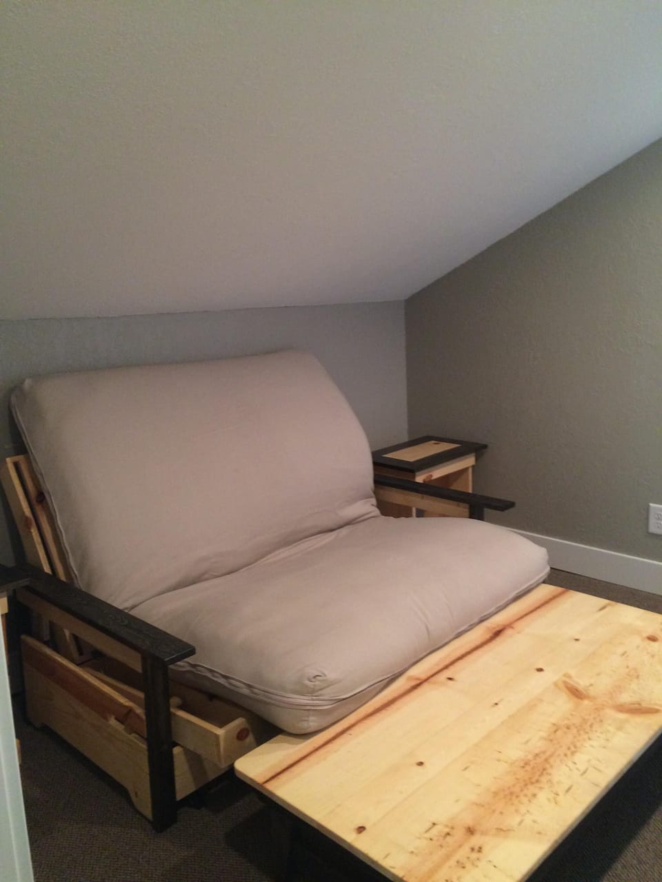 Sitting area on the second floor with futon and TV.