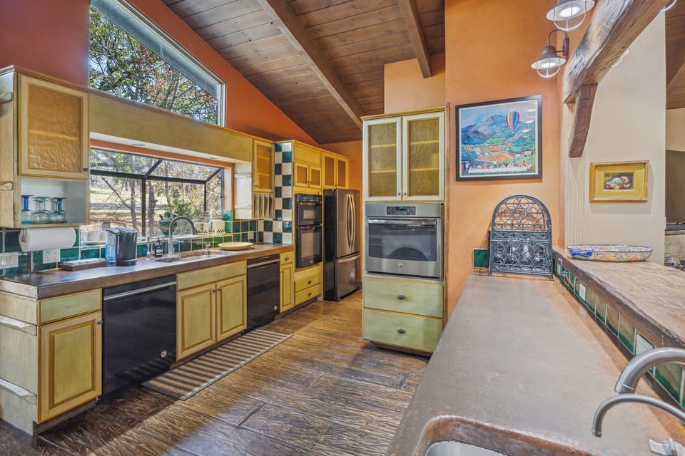 Concrete counters with 2 dishwashers & 2 ovens.  Great space to gather & cook!