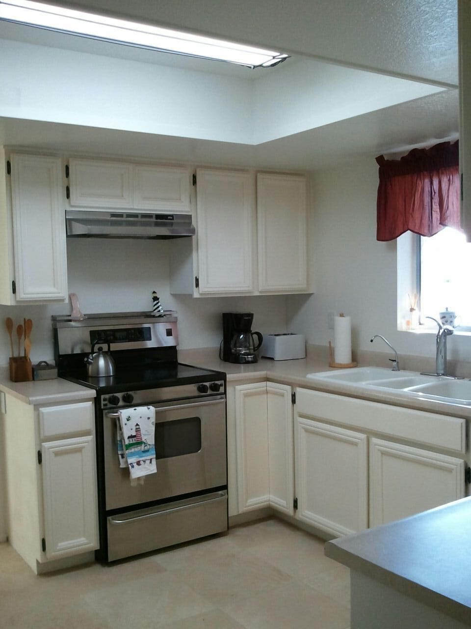 Kitchen with travertine tile and stainless steel appliances