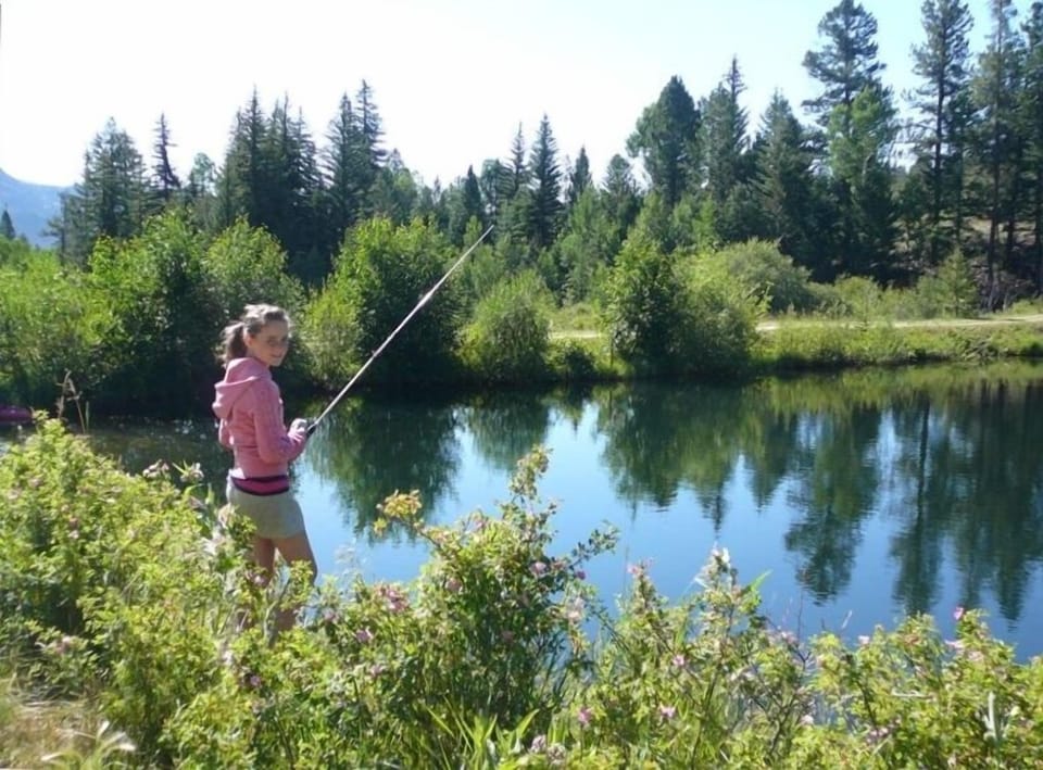 Wild roses line our PRIVATE stocked fishing pond --- everybody catches dinner