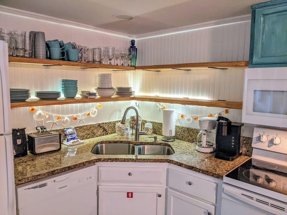 open shelves for plenty of food storage & granite counters and extra deep sink!