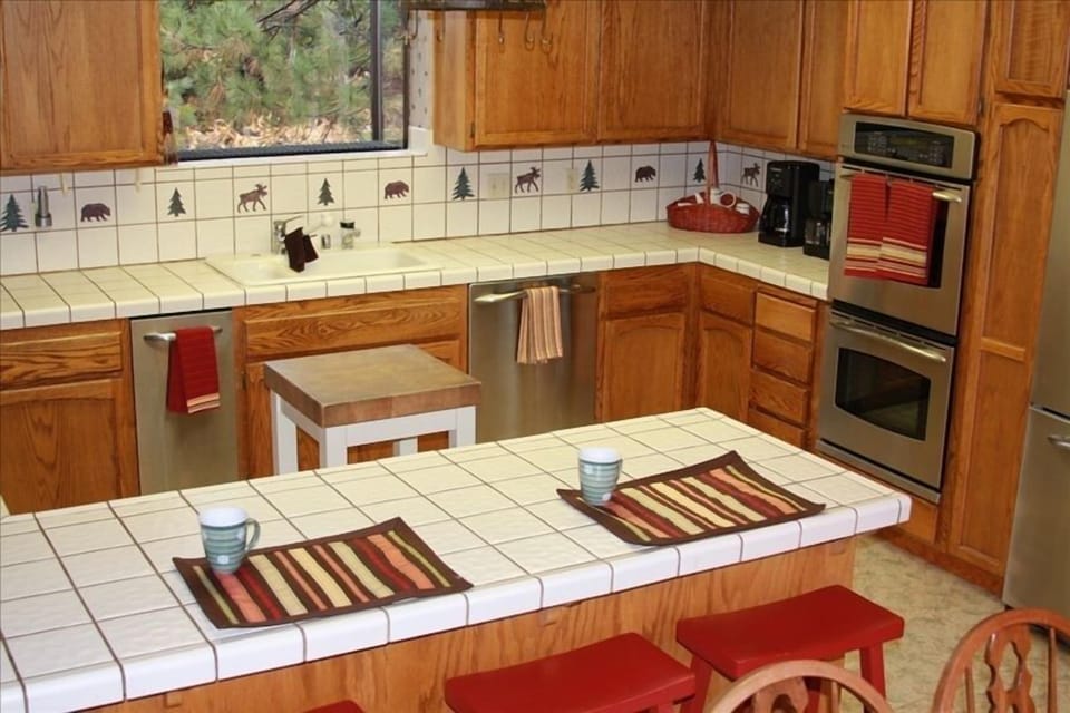 Kitchen with new stainless steel appliances, dual ovens, and breakfast bar!