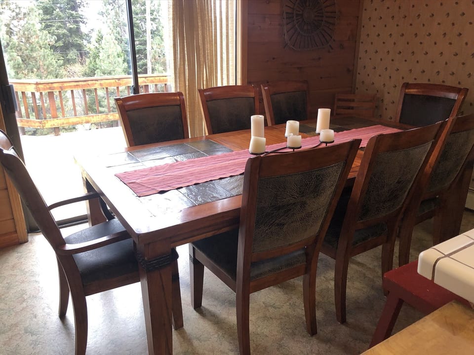 Dining table with a peek lake view. 3 stools at the kitchen bar as well. 