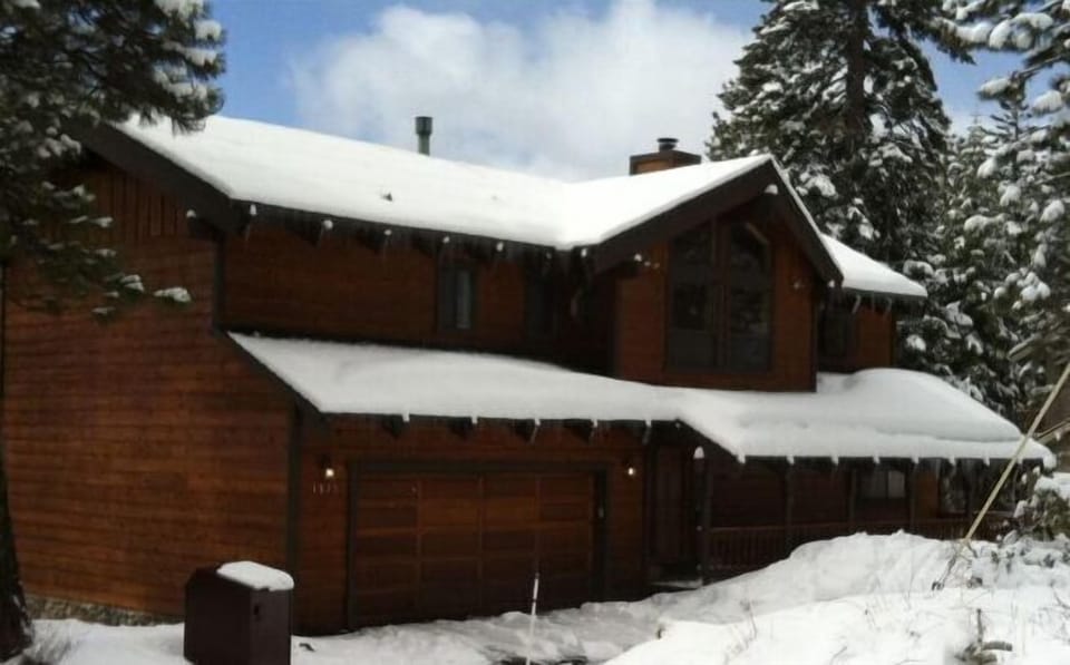 Entrance to our home with front deck, 2 car garage & additional parking in front