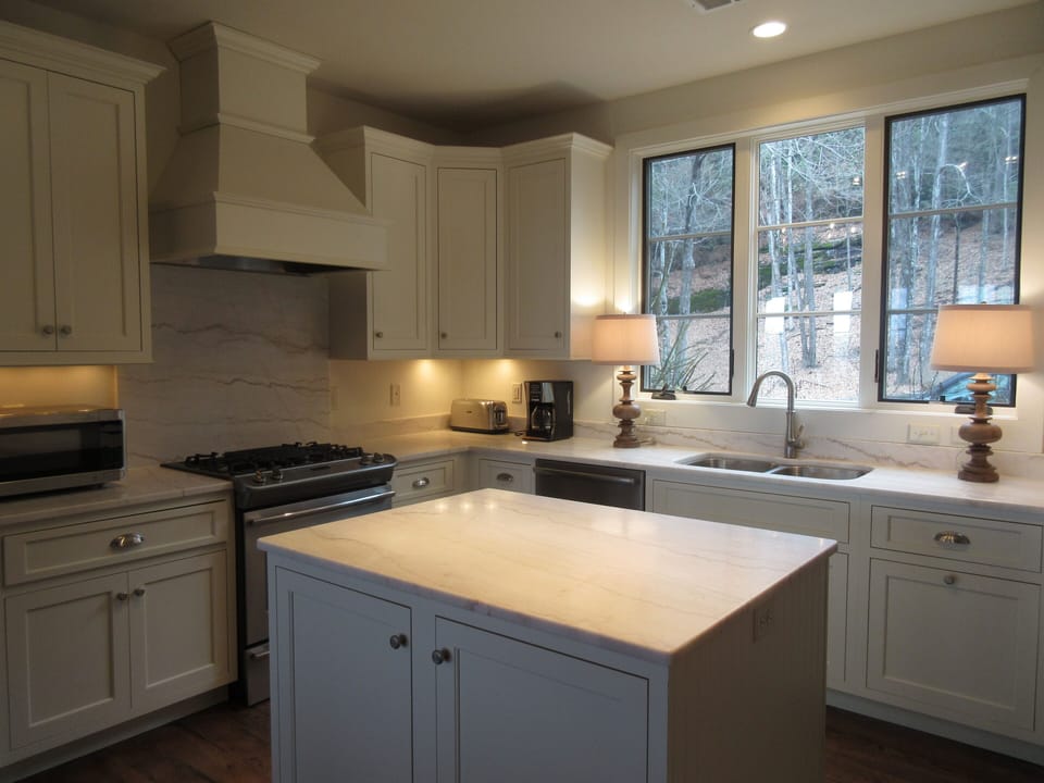 Gorgeous marble kitchen with island and gas range.