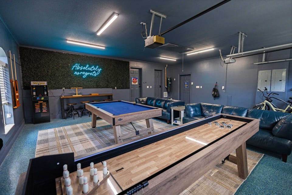 Unwind in your private game room with pool table, shuffleboard, and plush seating for unforgettable group entertainment.