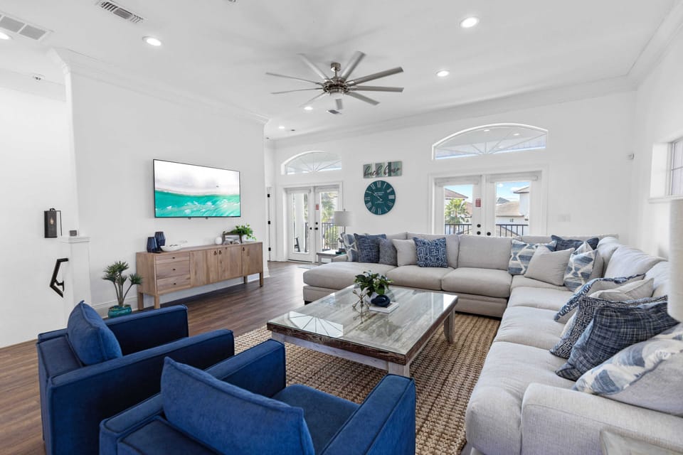 Sink into the spacious sectional sofa and enjoy movie nights on your large smart TV in this bright, airy living room.