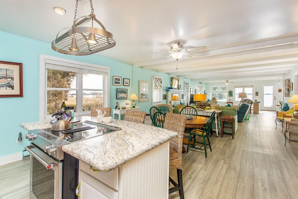 View from kitchen island through property to first dining area