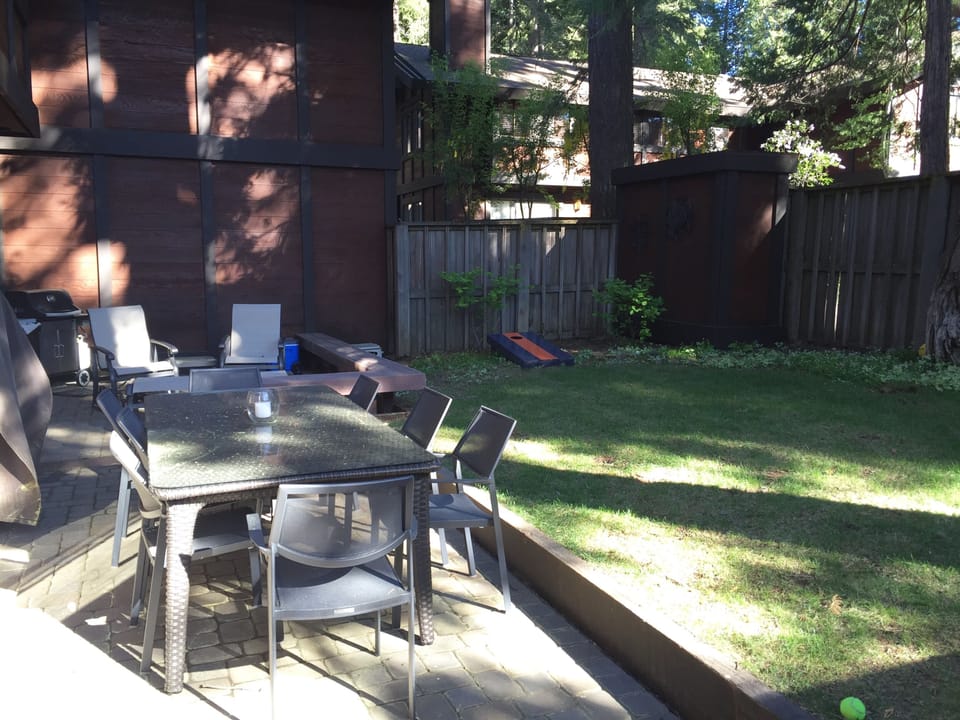 fenced in backyard with dining for 8