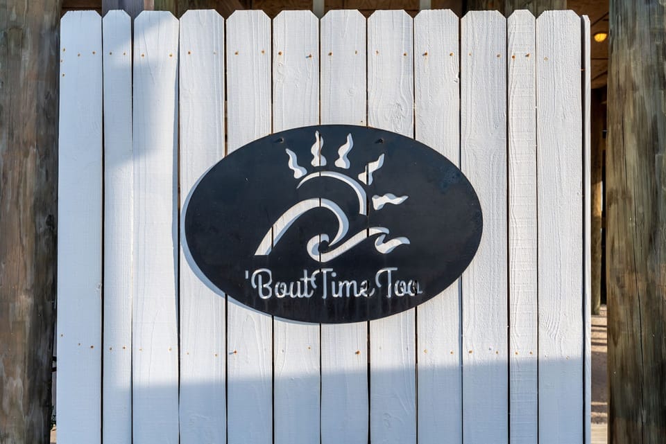 Charming property entrance with nautical-themed signage marking your arrival at 'Bout Time Too.