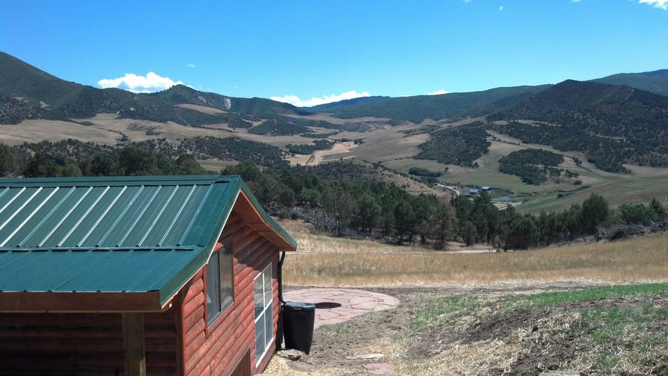 Cabin setting, looking at fire pit on patio and the Ranch