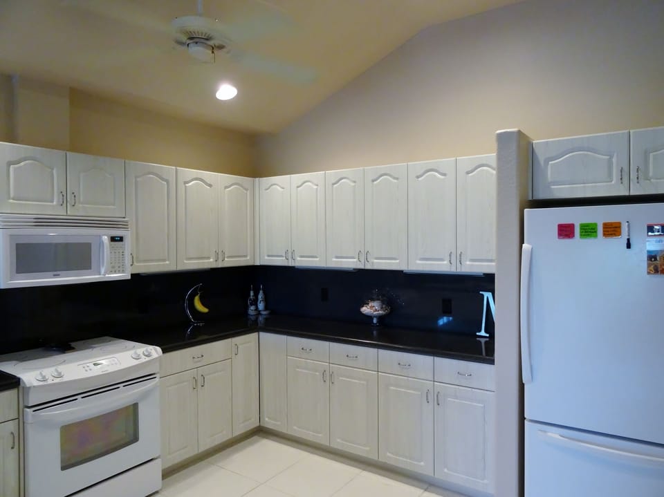 Kitchen has a full size refrigerator,  oven, microwave and dishwasher