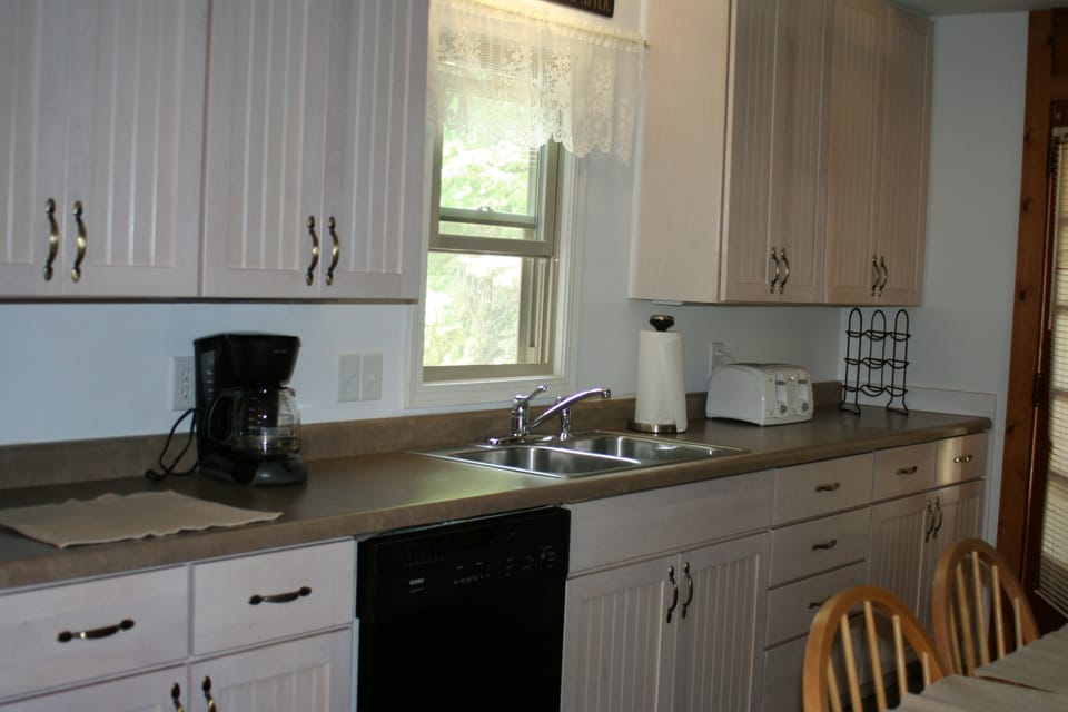 Kitchen with Coffee Maker, Dishwasher, toaster, microwave.