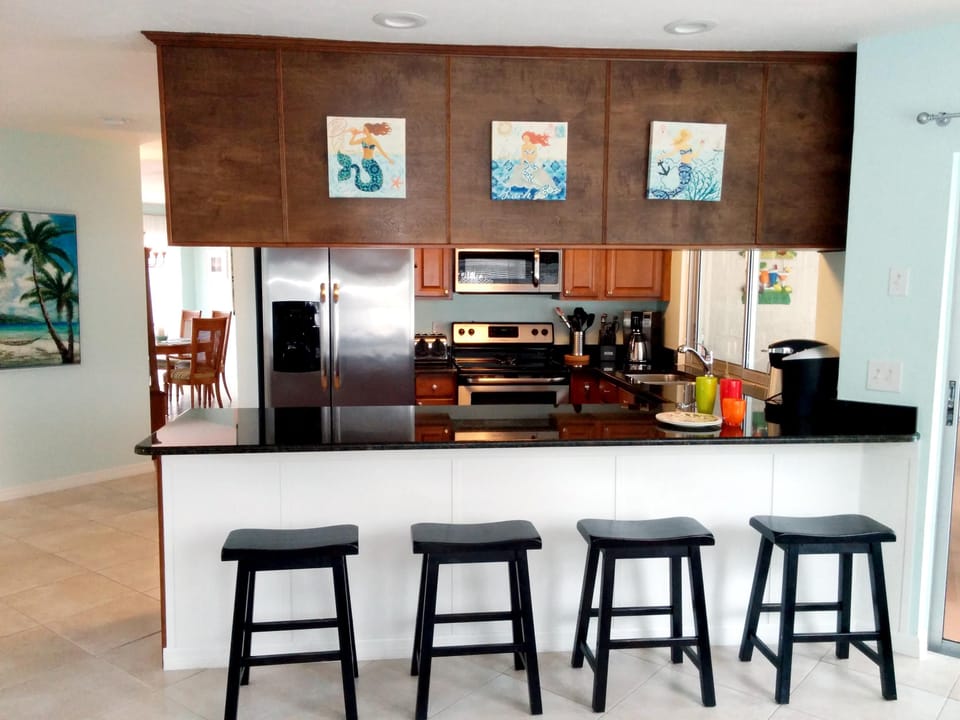 New wood kitchen with granite counters and stainless steel appliances