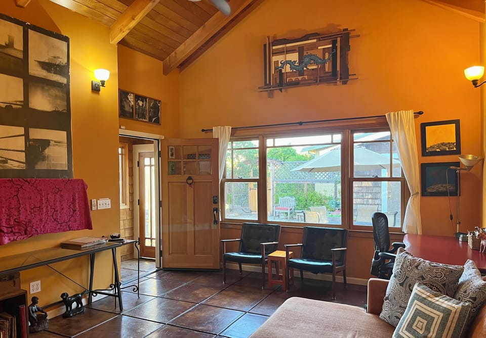 Open living space with TV, chaise lounge and work space.