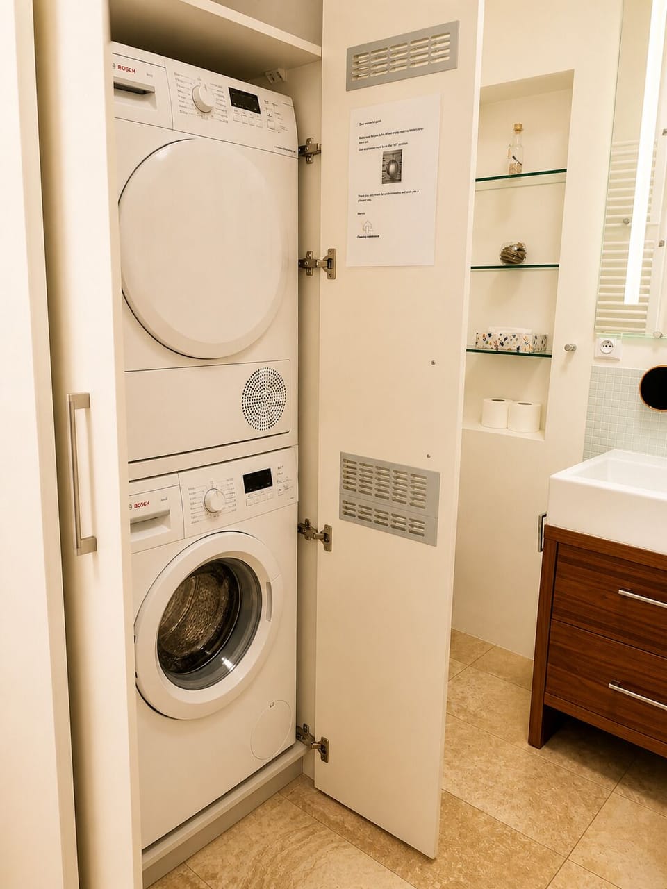 Washer-dryer set in studio bathroom for convenient in-unit laundry.

