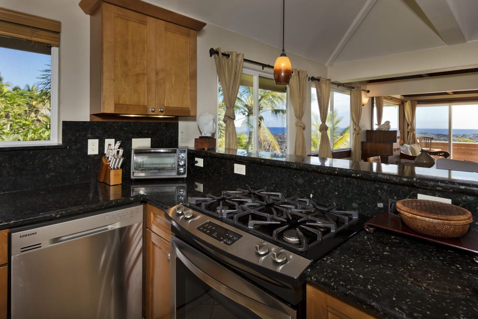 Open Kitchen looking into dining and living area and out to ocean.
