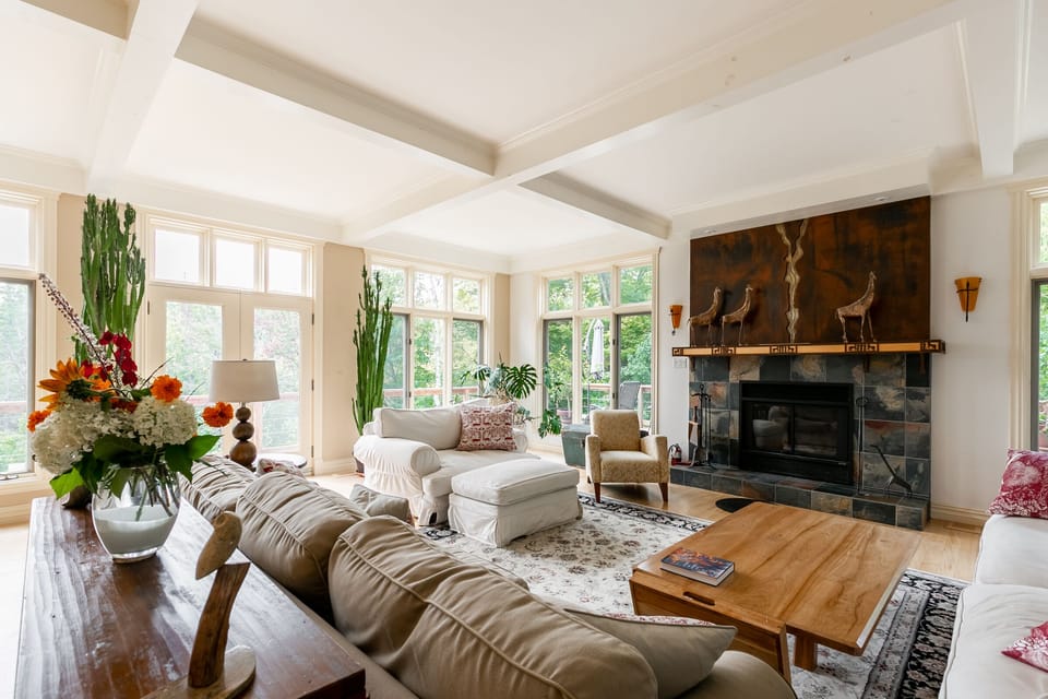 Cozy, shabby chic furniture allows for gatherings around the wood fireplace