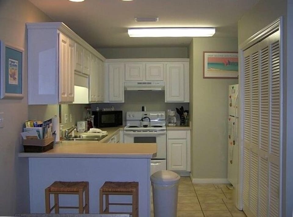 Fully-Stocked Kitchen, Bar with Stools; Laundry Center to the right.