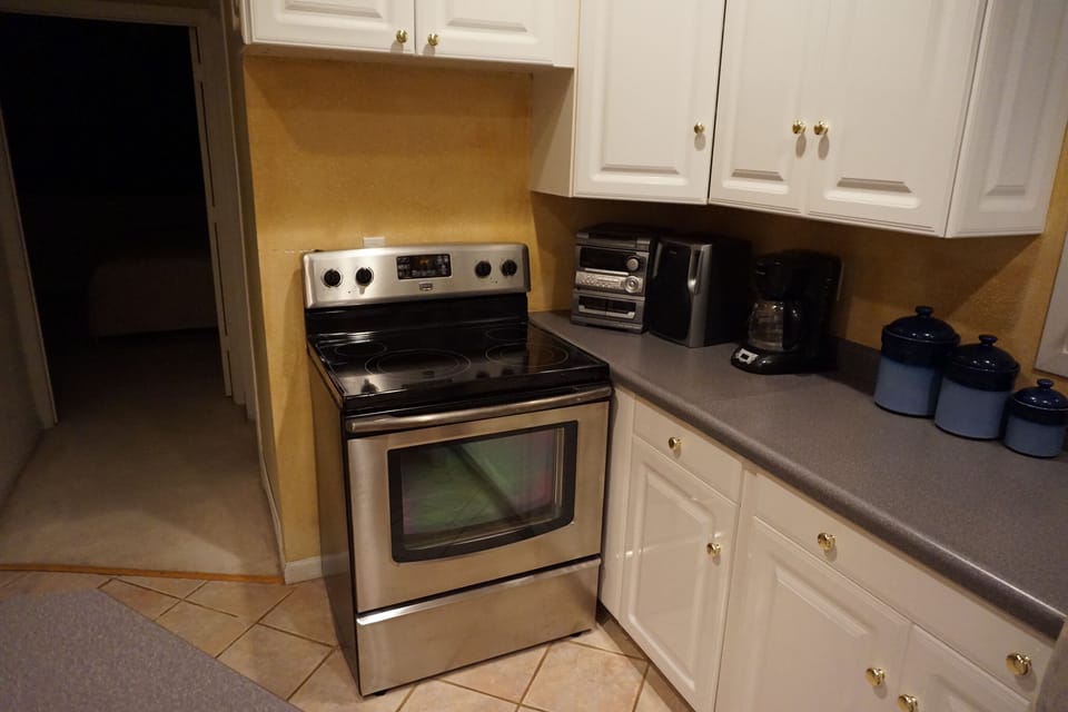 Newer stainless steel stove in Huge Kitchen with lots of cabinets and countertop