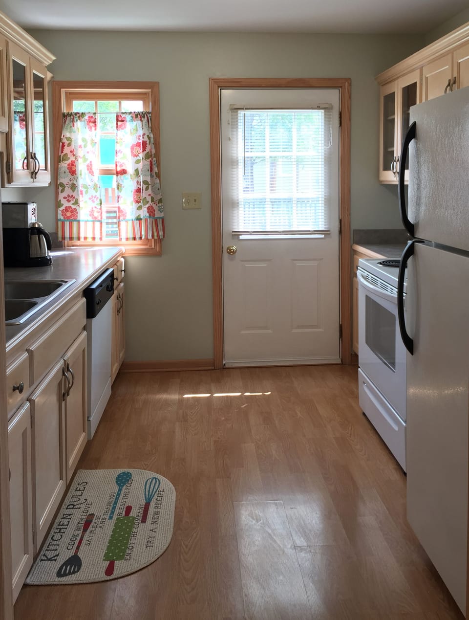 Updated kitchen has oven/stove, refrigerator, dishwasher, sink and coffeemaker.