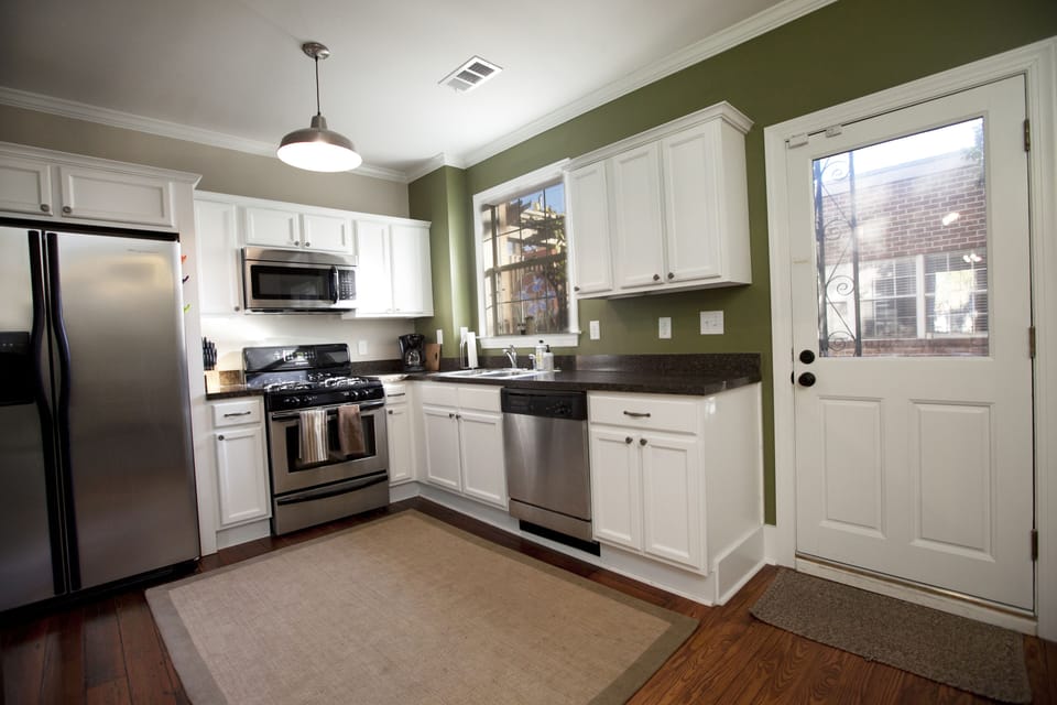 The kitchen is fully stocked with pots, pans, dishware, and utensils.