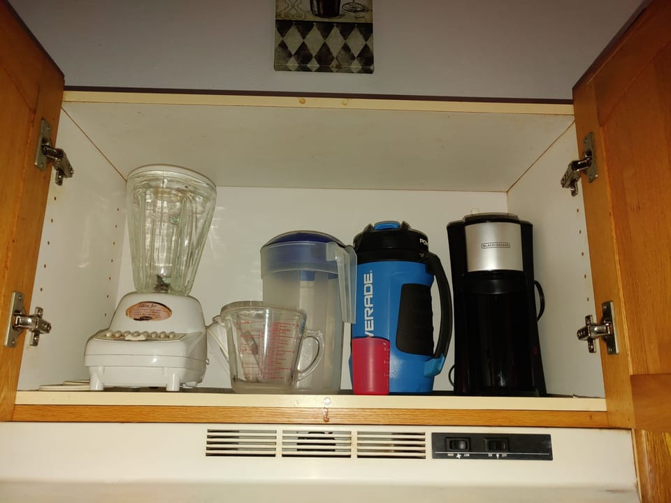 Above the gas stove single pod coffee maker, blender etc.
