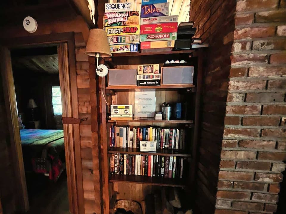 Sorry, no TV's!   Enjoy the CD collection, boardgames or choose 1 of many books within the cabin to read.