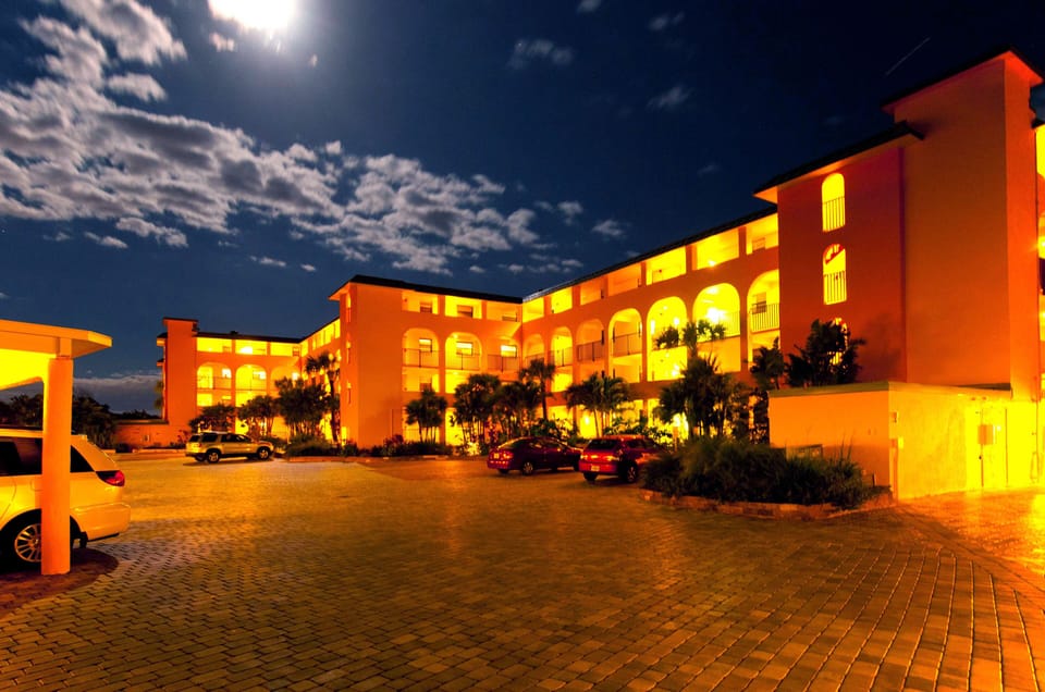 Exterior property at night.  4 buildings connected by walkways.  2 elevators.