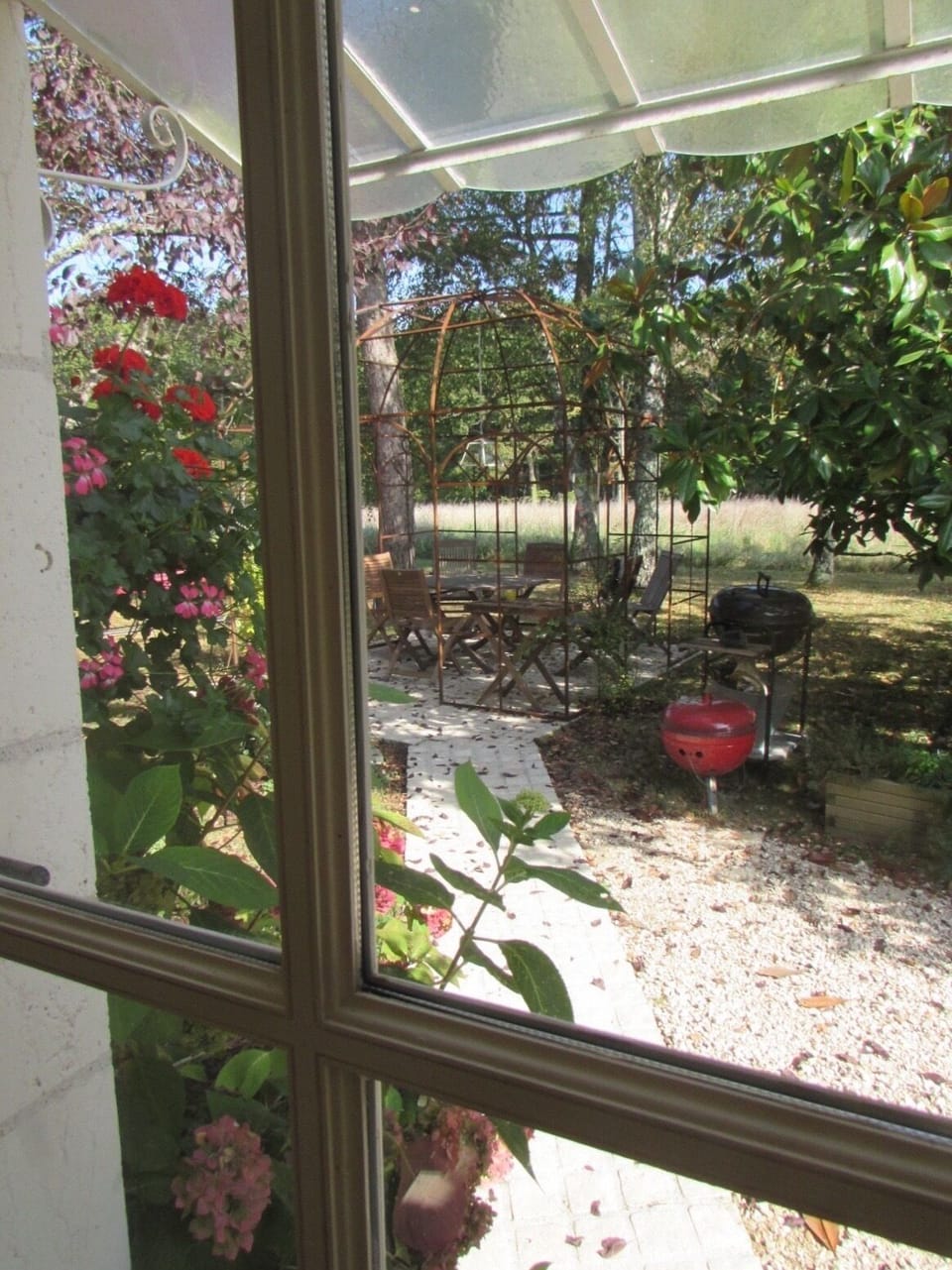 View of the patio under a gloriette from the kitchen door
