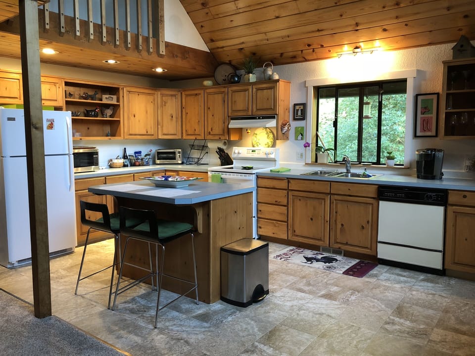 Airy gourmet kitchen with island.