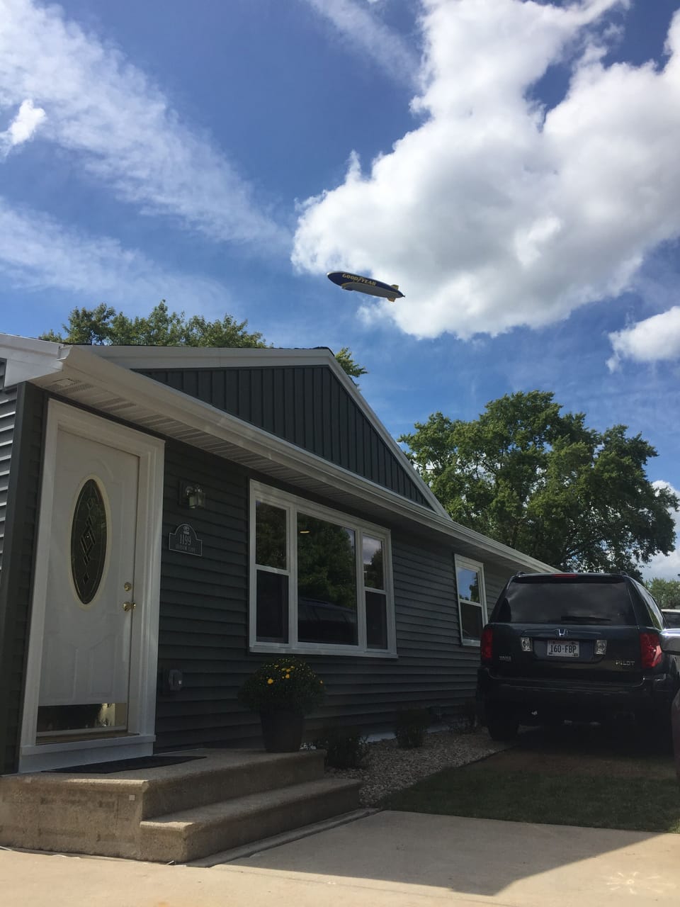front of house on game day, Blimp flying over