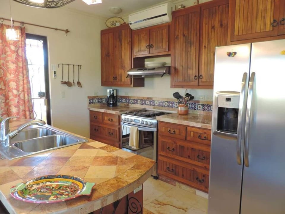 Second floor kitchen with stainless appliances. Fridge with purified water & ice