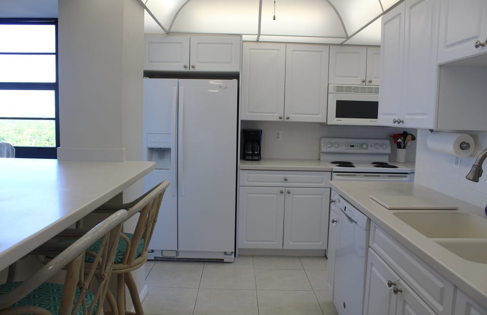 Fully equipped/updated wrap-around kitchen with ample storage and counter space.