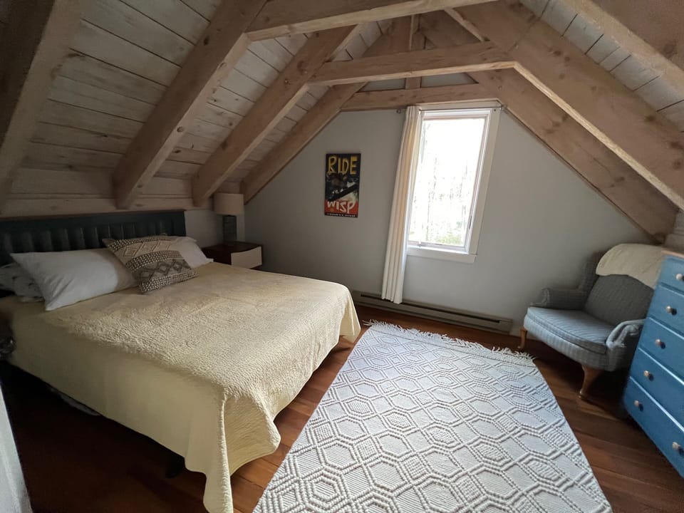 upstairs bedroom with beautiful exposed beams