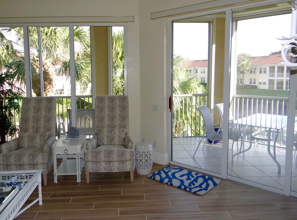 Living room with double wall of sliding glass doors 