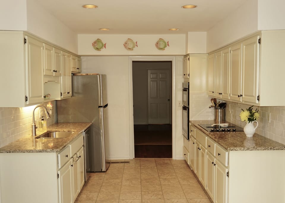 Renovated kitchen with new appliances and cookware.