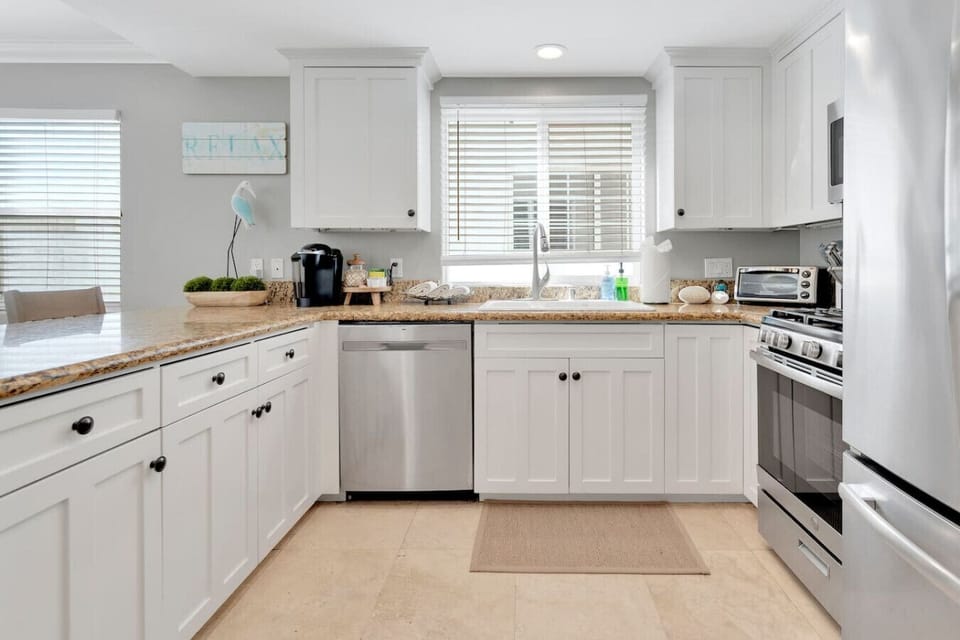 The fully stocked open kitchen allows you to cook, gather, connect, and dine.